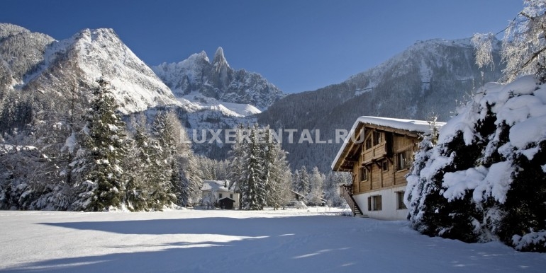 Chalet Lumiere Exterior with Les Drus and Field-Winter